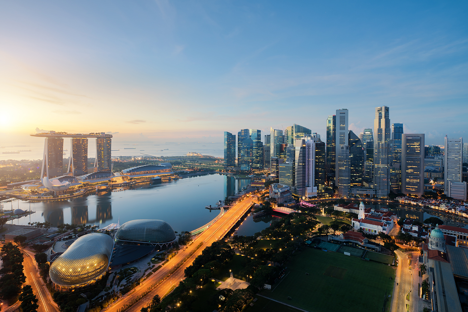 Aerial,View,Of,Singapore,Business,District,And,City,At,Twilight
